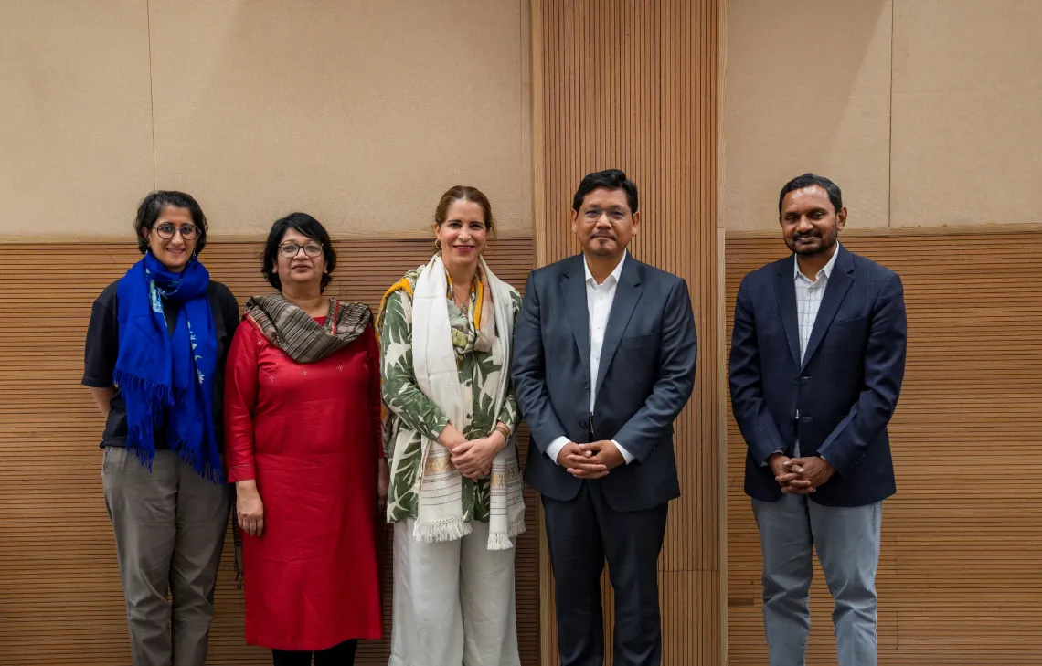 Five people stand together for a group photo against a wooden-panelled wall. Among them are the Chief Minister of Meghalaya, Conrad K. Sangma, in a grey suit, and UNICEF India's Chief of Field Services, alongside three colleagues, following a meeting on child and maternal health priorities in the state.