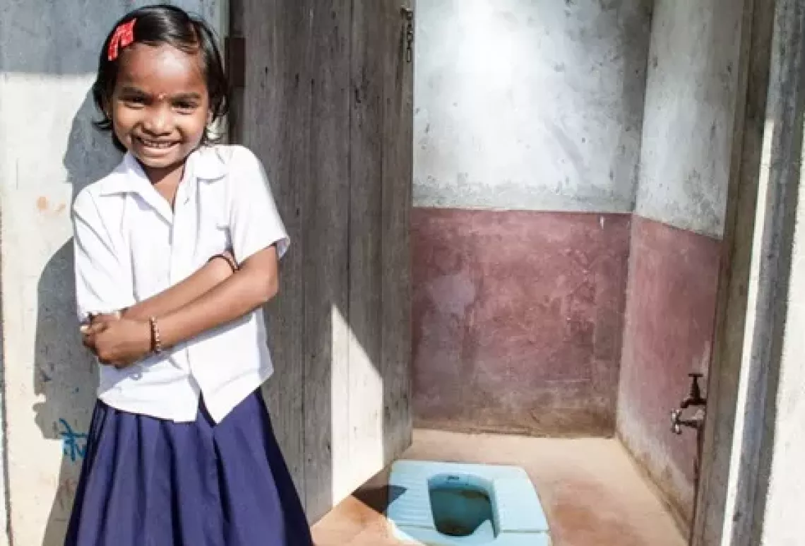 On 9 October 2012, Vaishnavi Navalji Dadmal, 9, poses for a photograph at her residential toilet in Chandrapur District, Nagpur. 