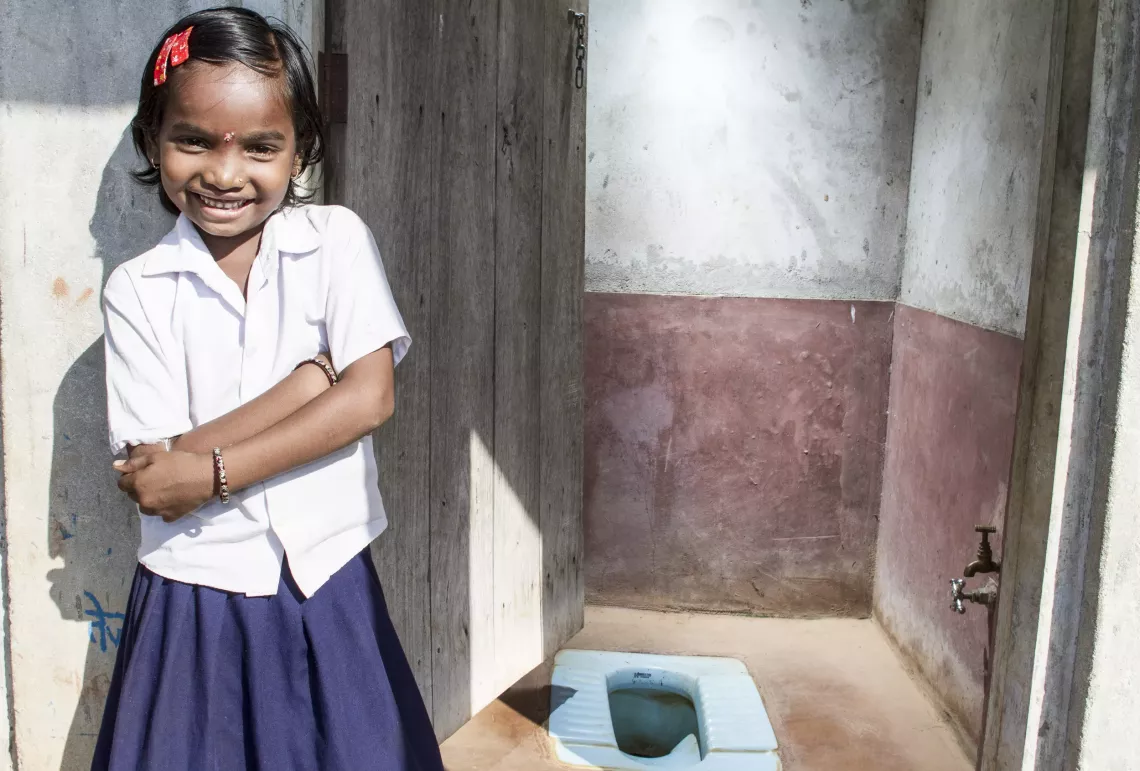 On 9 October 2012, Vaishnavi Navalji Dadmal, 9, poses for a photograph at her residential toilet in Chandrapur District, Nagpur.
