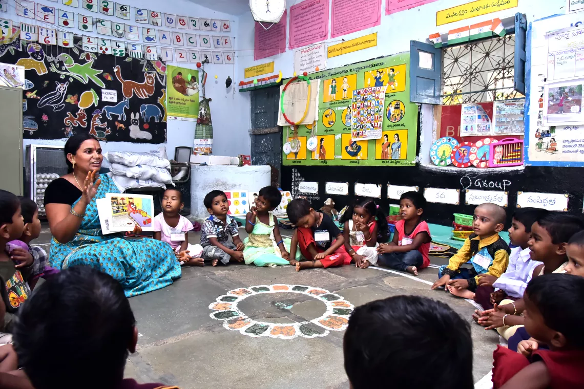 Anitha, an Anganwadi teacher, engaged with children in a storytelling activity at Anganwadi Centre-II, Cheriyal Village, Mandal - Kandi, District Sangareddy, Telangana.