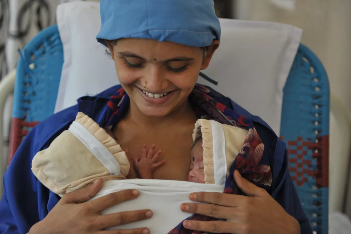 A mother with her twin boy and girl babies inside the Kangaroo Mother Care (KMC) Ward at the Government hospital in Nalgonda District. Telangana State, India.