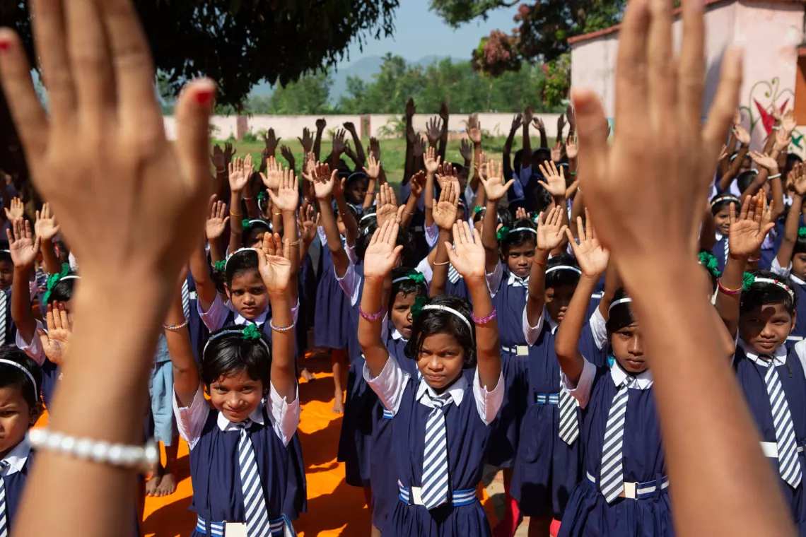 Students from the 3rd grade take part in a mass dry hand wash demonstration at a weekly student cabinet meeting at the Bhakurguda ashram school in Rayagada district.