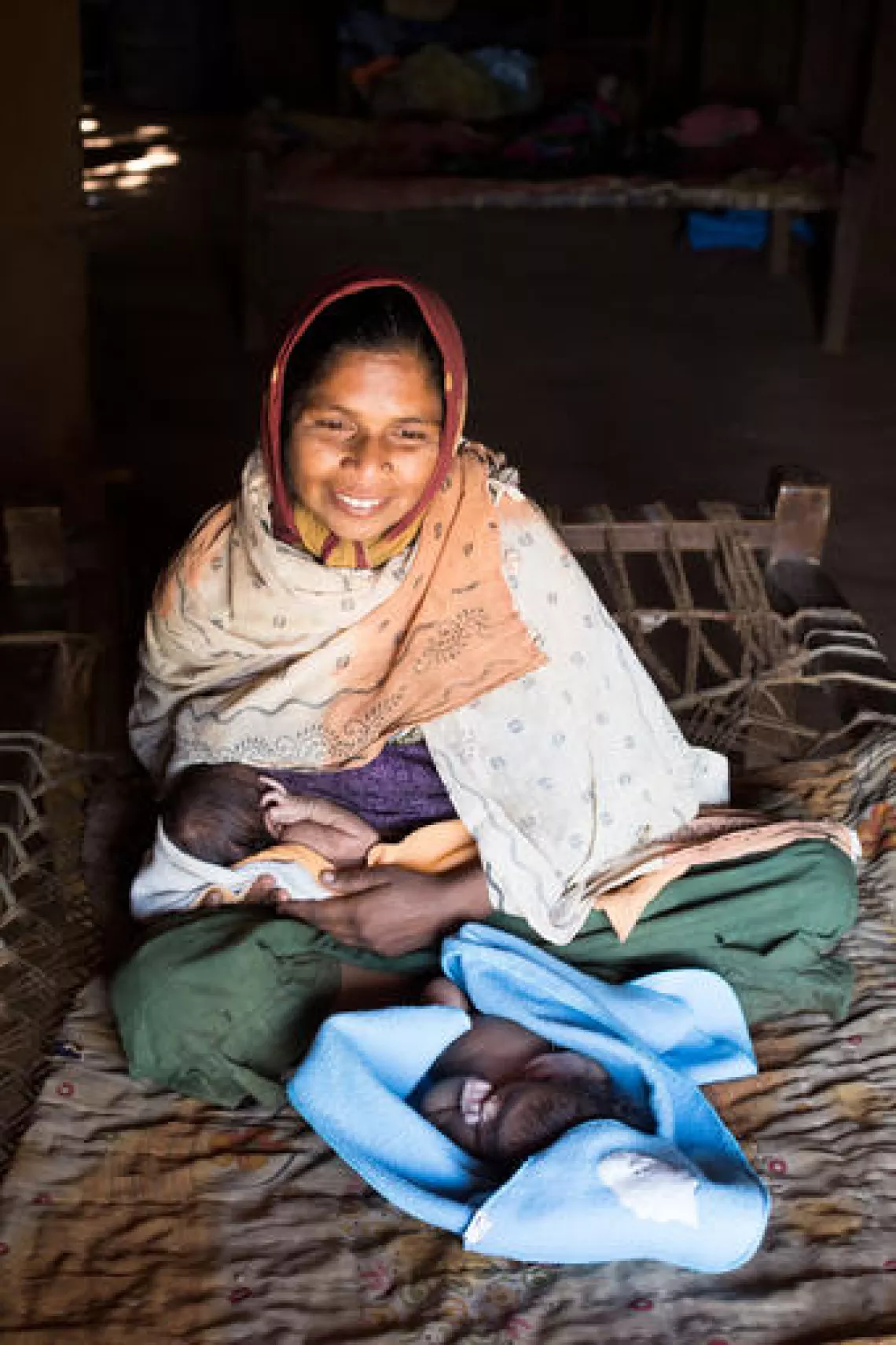 Thirty-five-year-old, Sevalaben Vasava, with her 14-day-old twin daughters, in Godada Village, Narmada District, Gujarat