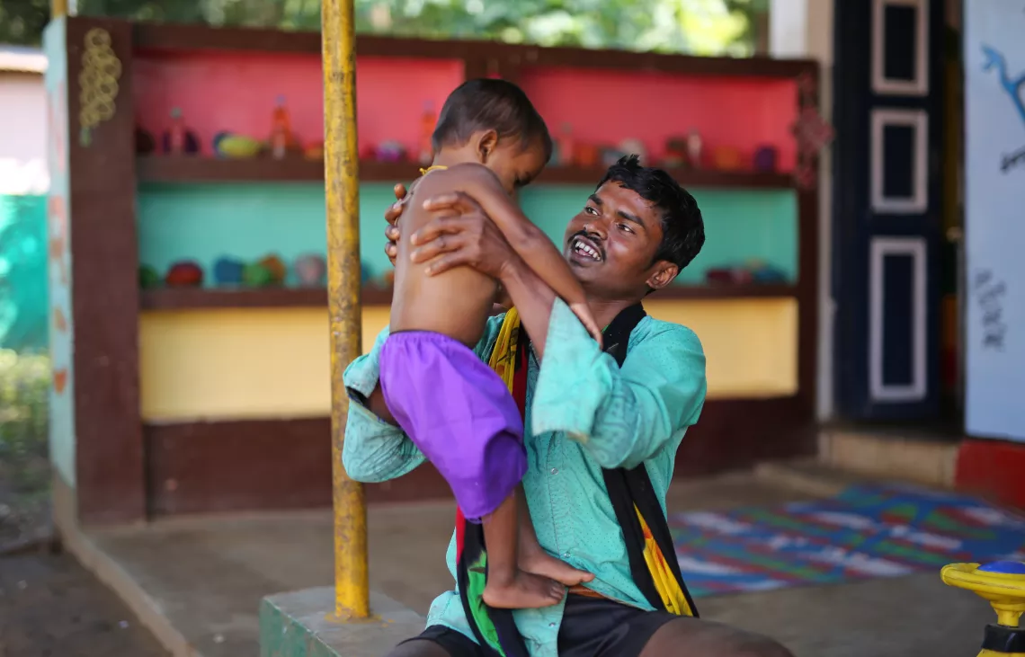 A tribal father plays with his baby at Nutrition Rehabilitation Centre in Orchha, Narayanpur, Chhattisgarh.