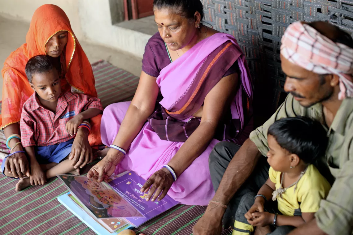 Anganwadi worker Manju Agarwal (middle) with Daulat singh (right) 30 &ndash; year old, illiterate father of 2 children and his wife Chanpa Bai (Left) 26 year &ndash; old Illiterate during regular home visit.
