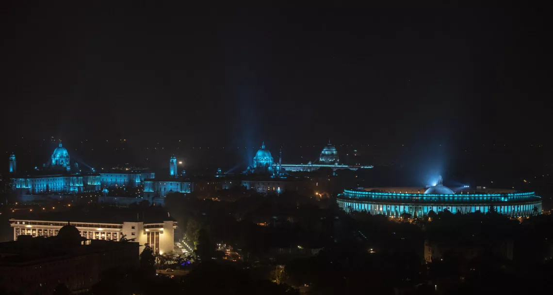 The parliament buildings are lit blue