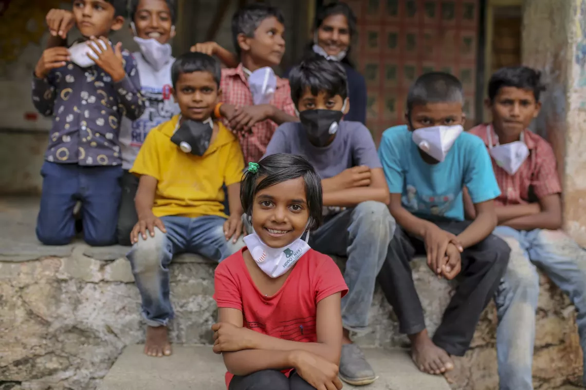 Sukanya Sathey, 8, along with other children, poses for a photograph outside the primary school at Shirasgaon Mandap village in Jalna, Maharashtra, on Sunday, October 19, 2020. 