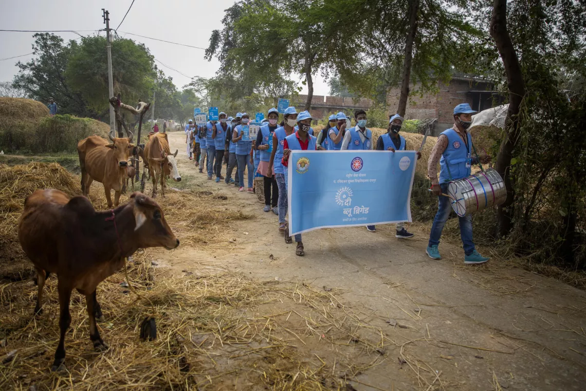 The Blue Brigade Volunteers rallying the village on creating awareness on COVID-19 