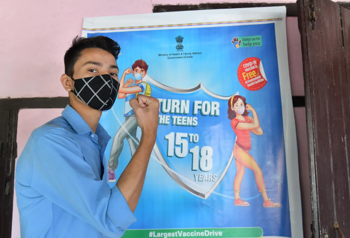 Pranabjyoti Chetri, a student of Class 11 poses for a photograph after taking a dose of COVID-19 vaccine during a vaccination drive for people in the 15-18 age group at a Government School, in Assam. 