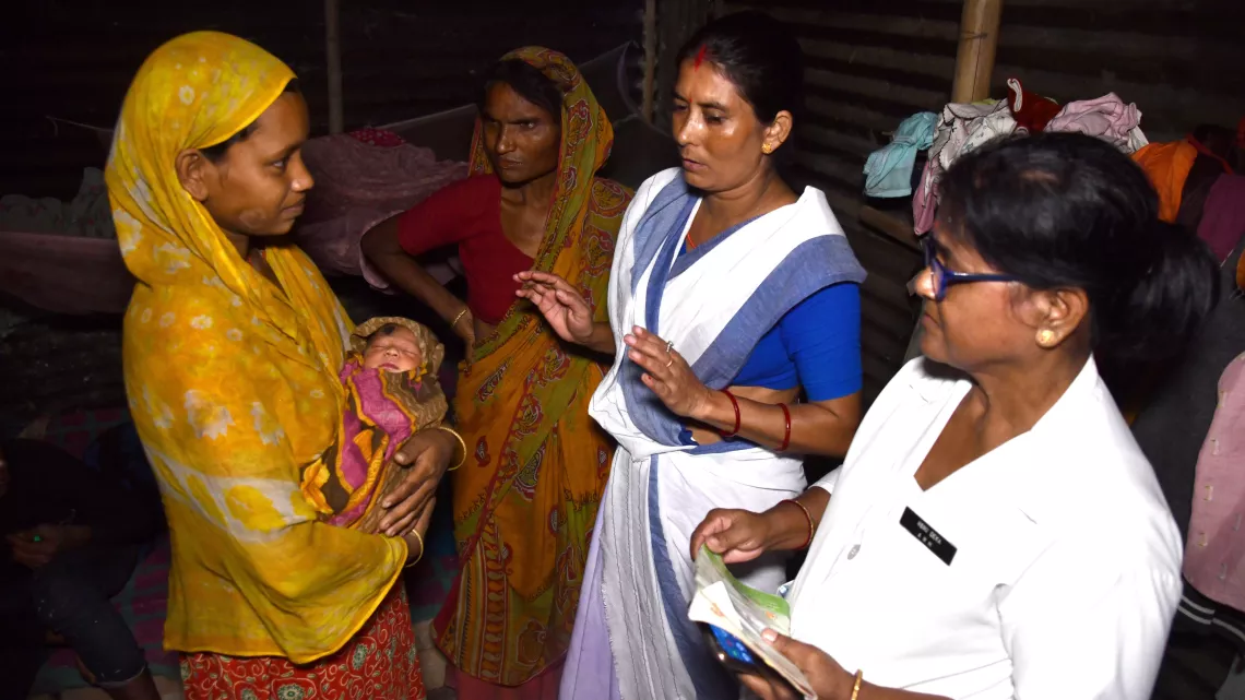 Reshmina Parbin, migrant worker with her newborn health workers at a brick kiln at Darrang district.