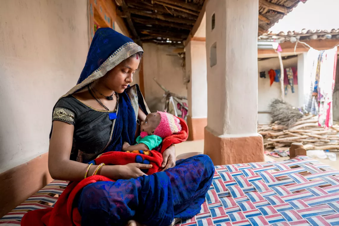 Pramila feeds her son Tikesh (3 months) Location: Kanthi Village, Ambikapur, Chhattisgarh, India