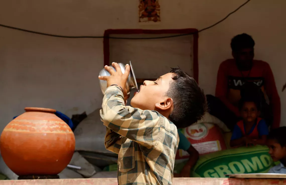 Nine-year-old Sachin &nbsp;is captured drinking water from an earthen pot during a heatwave at his &nbsp;home in Barki village, Karauli district, Rajasthan, India.