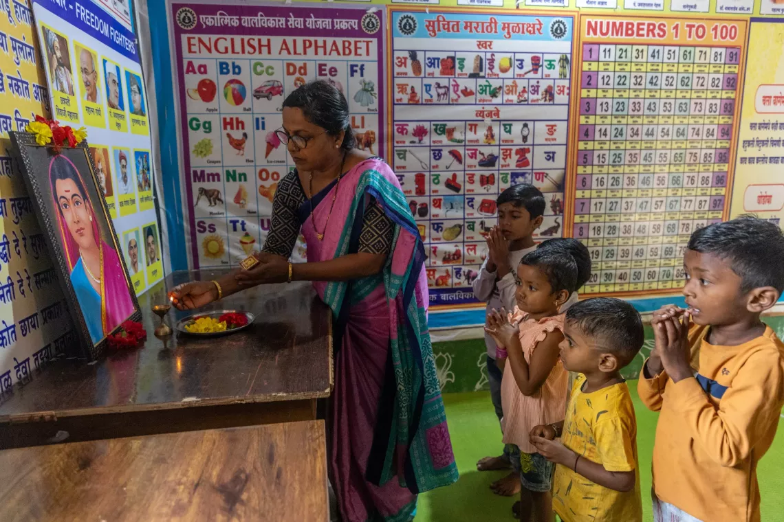 Anganwadi worker, Ranjita Rupesh Moon (L), 48, along with children perform prayer before start the day at the Anganwadi no 74, Warud village, in the District of Amravati, Maharashtra , India, 22 October 2024. 