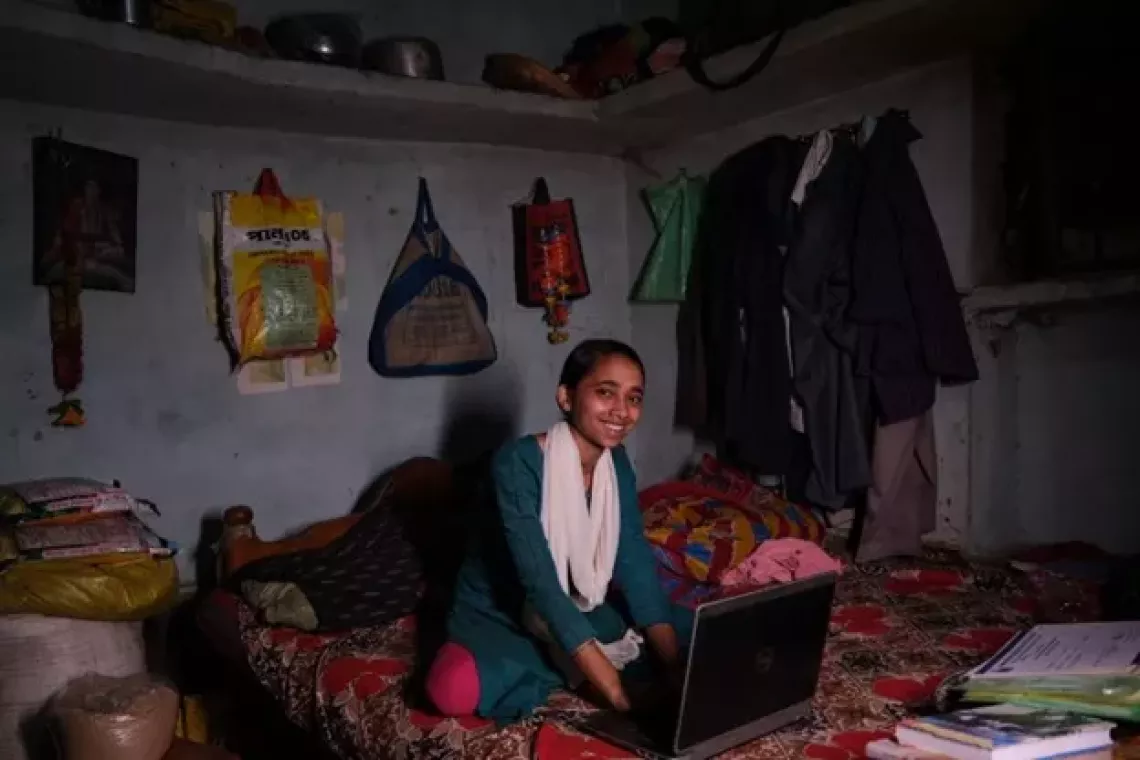 Meena is studying on her laptop to become&nbsp;a&nbsp;nurse.