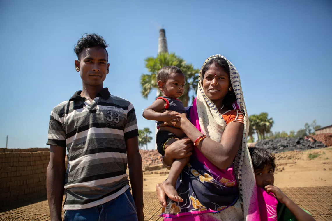 Mother and father holding baby Dhanraj.