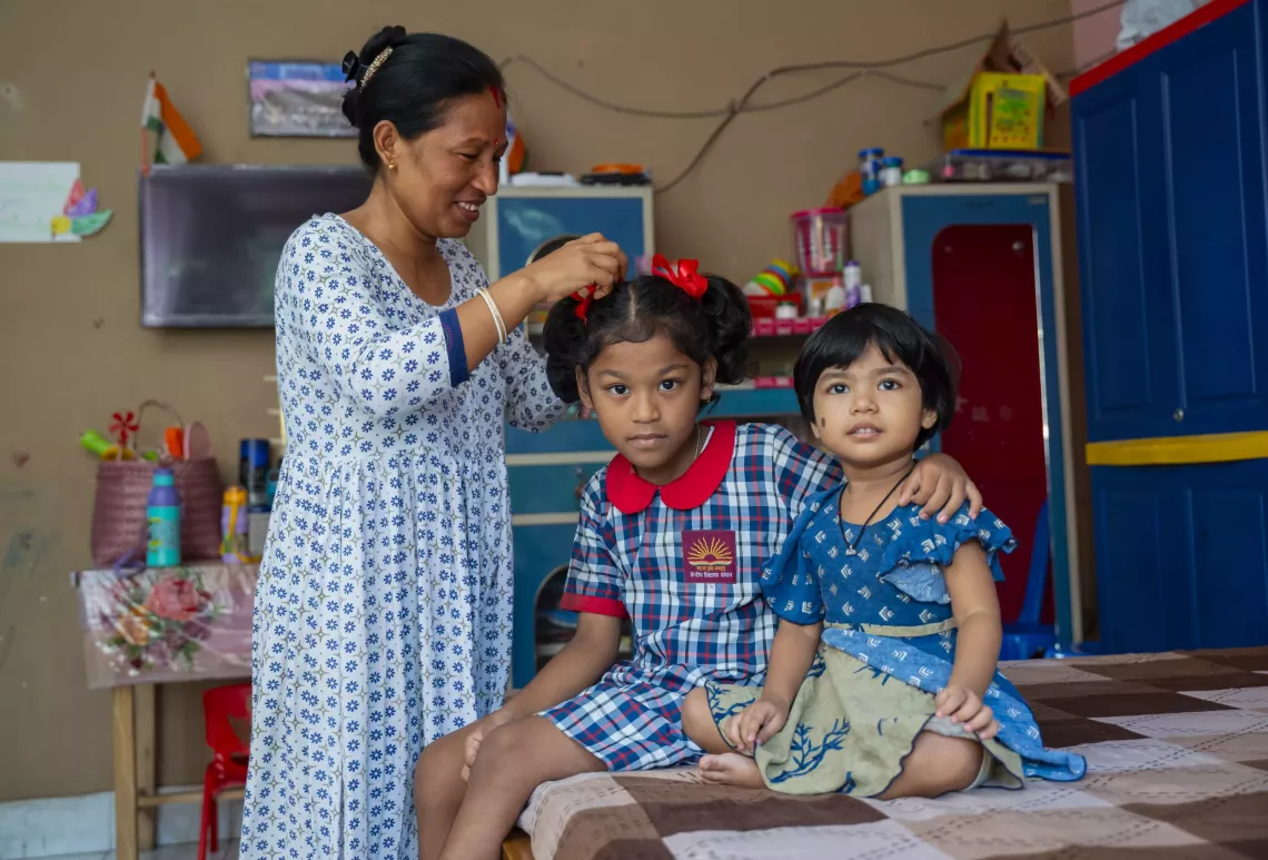 Nirupoma playing with her daughters.