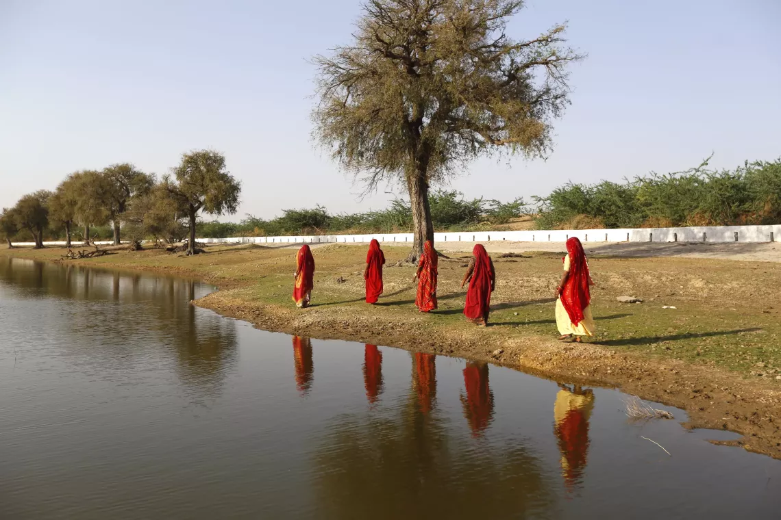 Leela Khatun,  40, (on the right), is seen strolling around the traditional water reservoir (naadi/ talab) with her fellow &ldquo;Jal Sahelis&rdquo;  (water warriors) in Kanasar village, located in the drought-prone area of Phalodi district in Rajasthan, India
