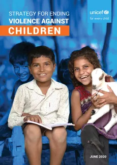 A boy and a girl sitting together with blue background, the girl is holding a kid, baby goat