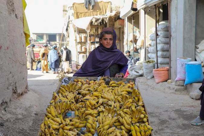 A boy selling bananas.