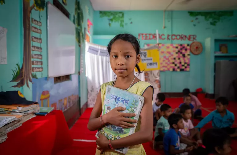 10-year-old Korobi Medhi, in a relief camp after the devastating floods in Palasbari, Assam, is grateful for the books and the chance to play with friends in the child-friendly spaces established by UNICEF