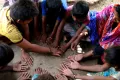 Children playing traditional/indigenous games outside their house. Village Kodarvi Ranpur of Banaskantha District of Gujarat state, India. 