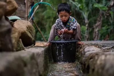 A boy washes his face