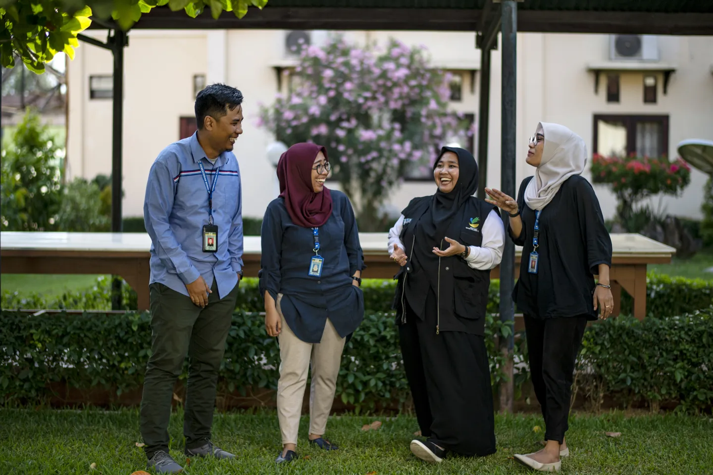Robby Saputra (33), Ramadhani Sri Handayani (32), Nurfanny (30), and Triyana Sari (30) pose in front of the camera in the park in the Social Office office area in Palu, Central Sulawesi, Indonesia, on 11 September 2019. 