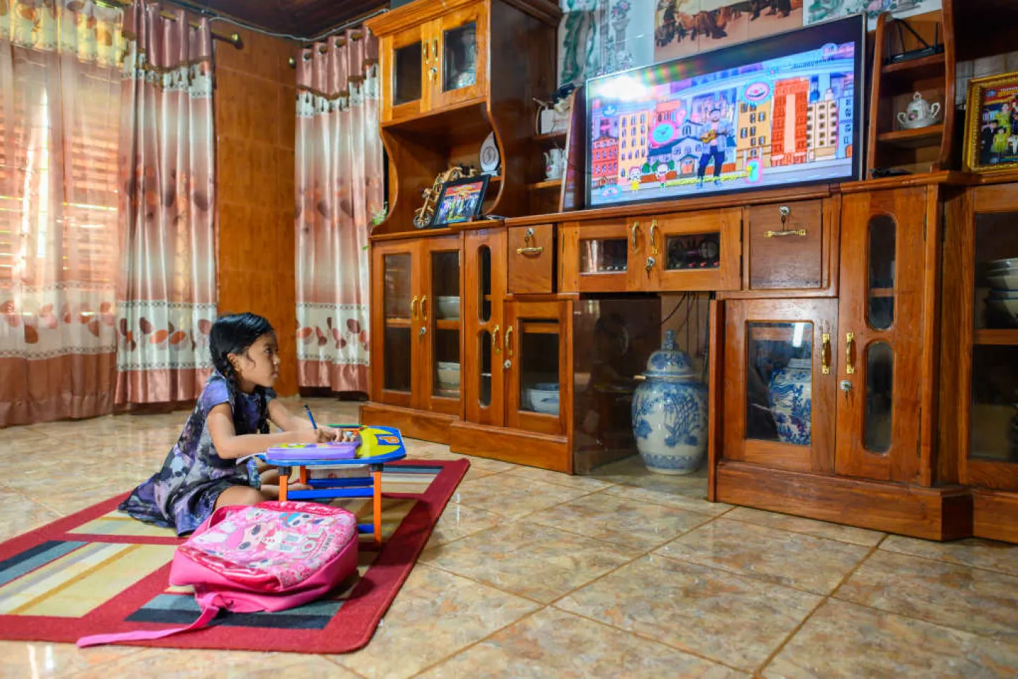 Moreyna follows an educational TV programme at home