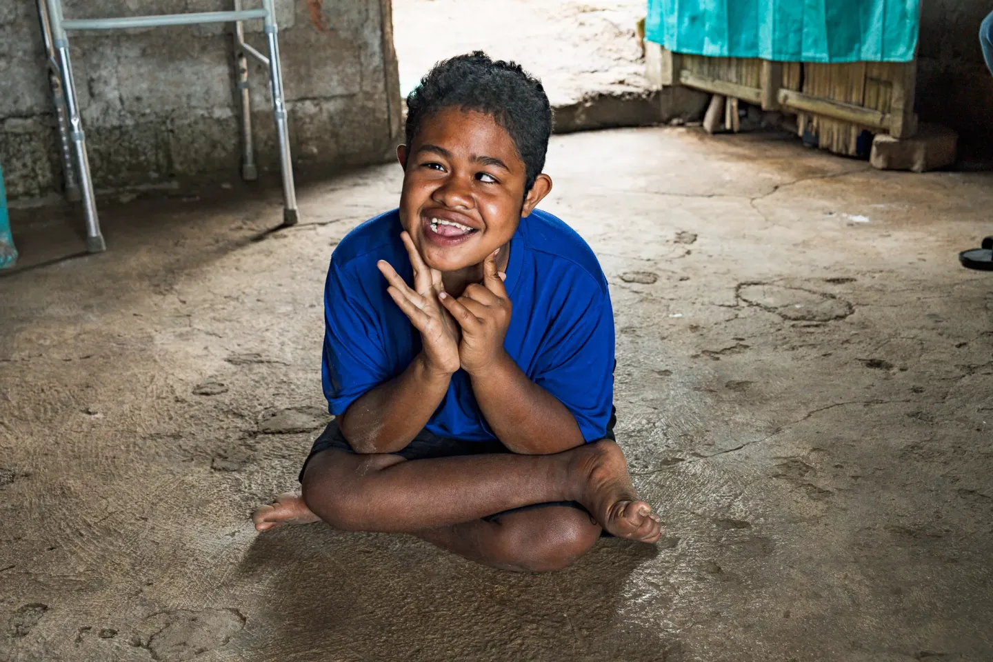 Febriari Uba Sisa, 14, a person with disability, sits in her house in Larantuka Island, East Nusa Tenggara. 