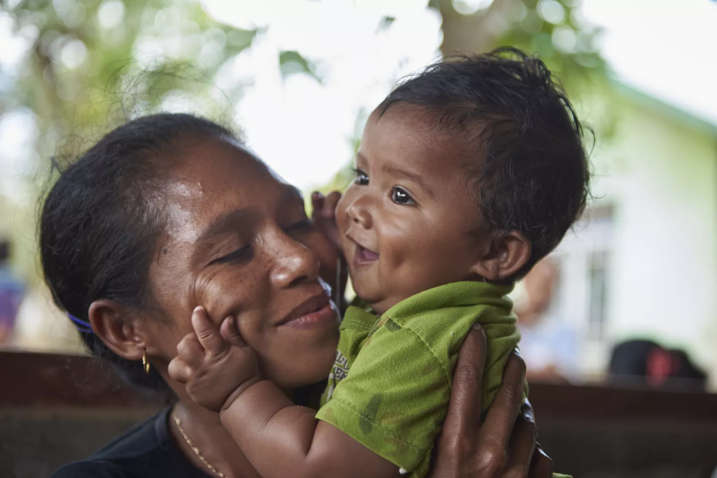 Delila Tamelab sits with her son