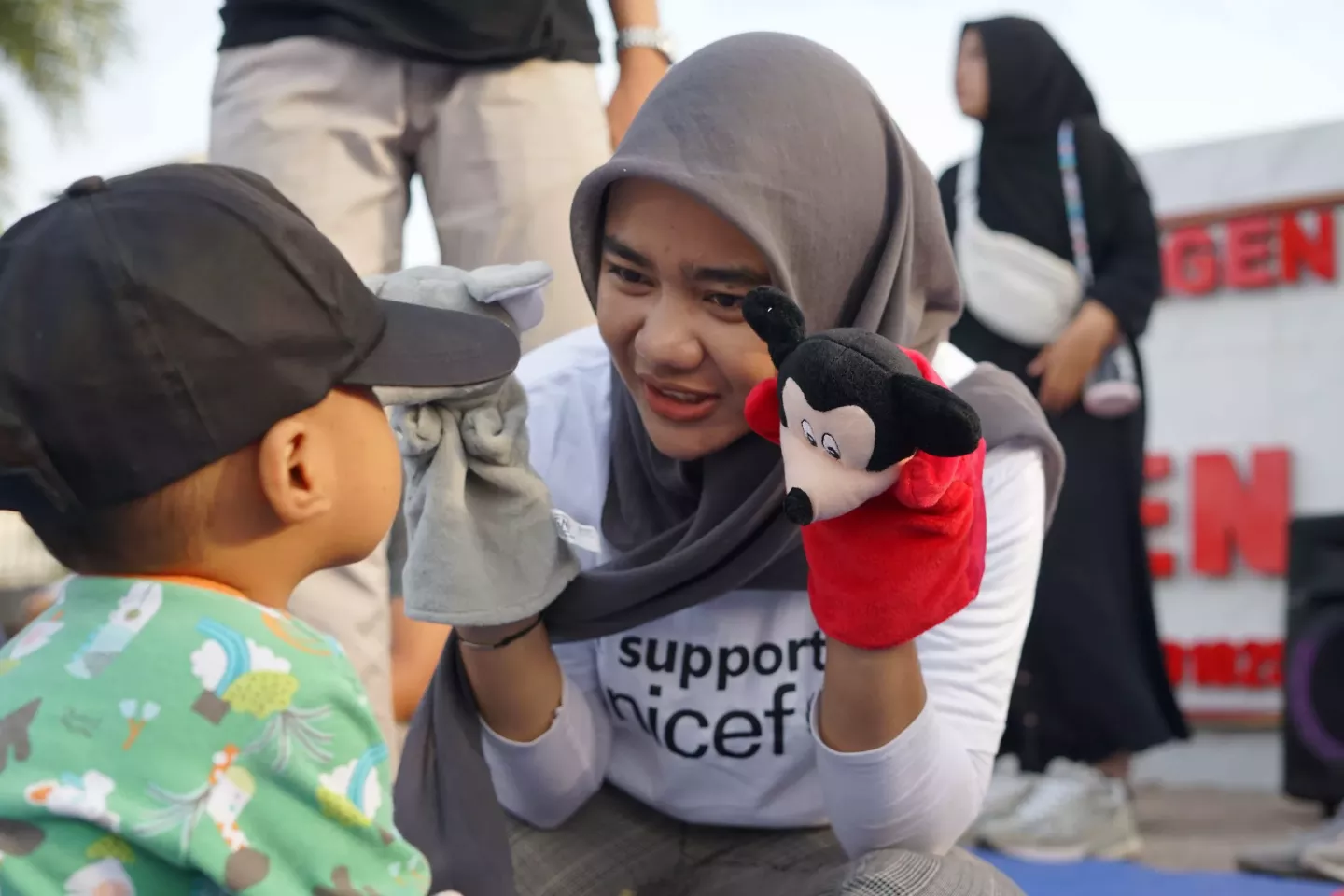 A young woman does storytelling to a child