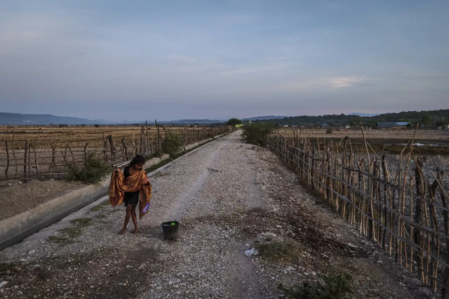 A girl walks amidst drought