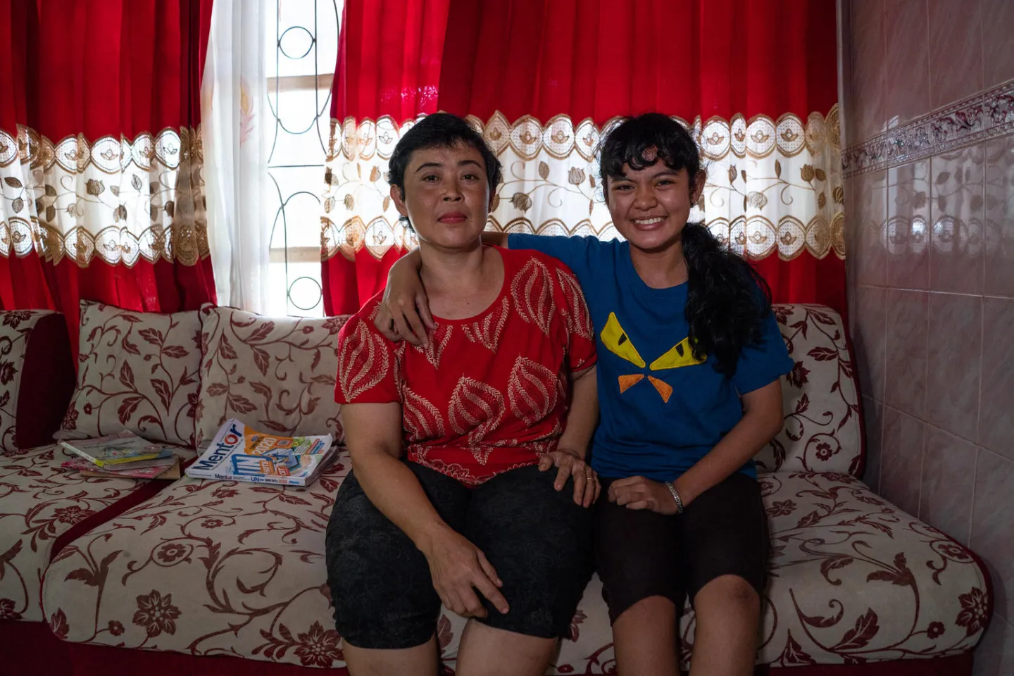 Flora Dita Cahyani and her mother sitting at their home
