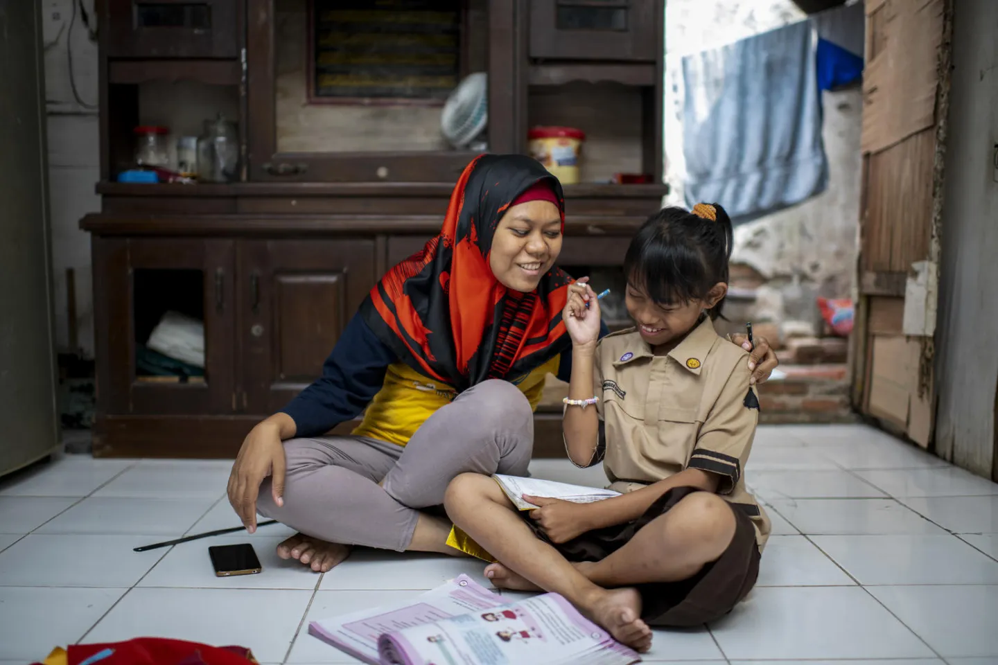 A mother laughing with her daughter