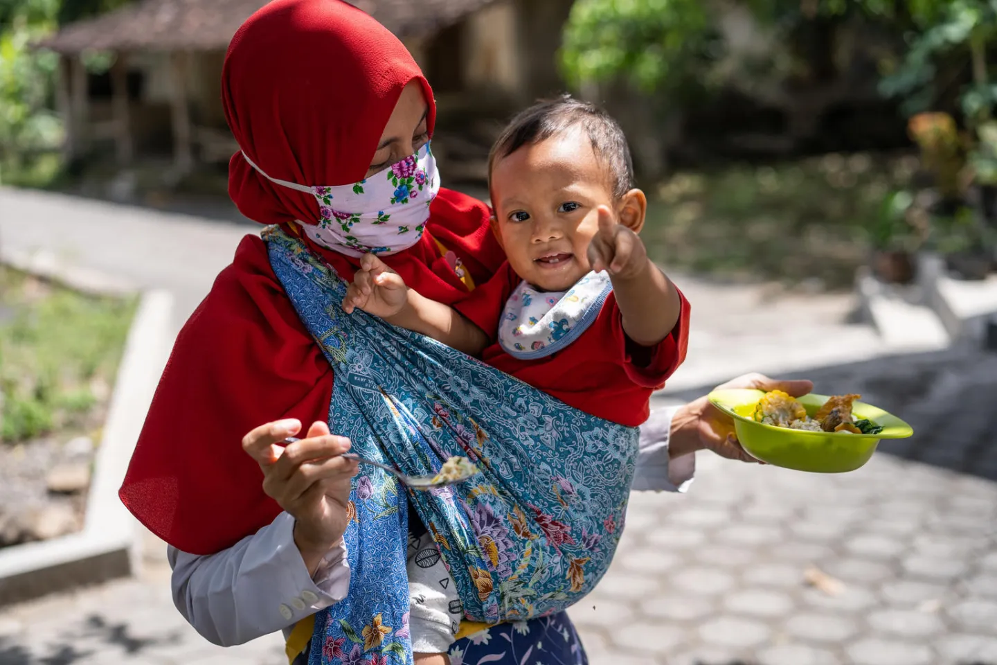 A mother feeds her son