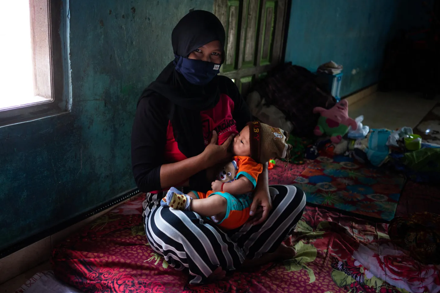 A mother breastfeeds her son