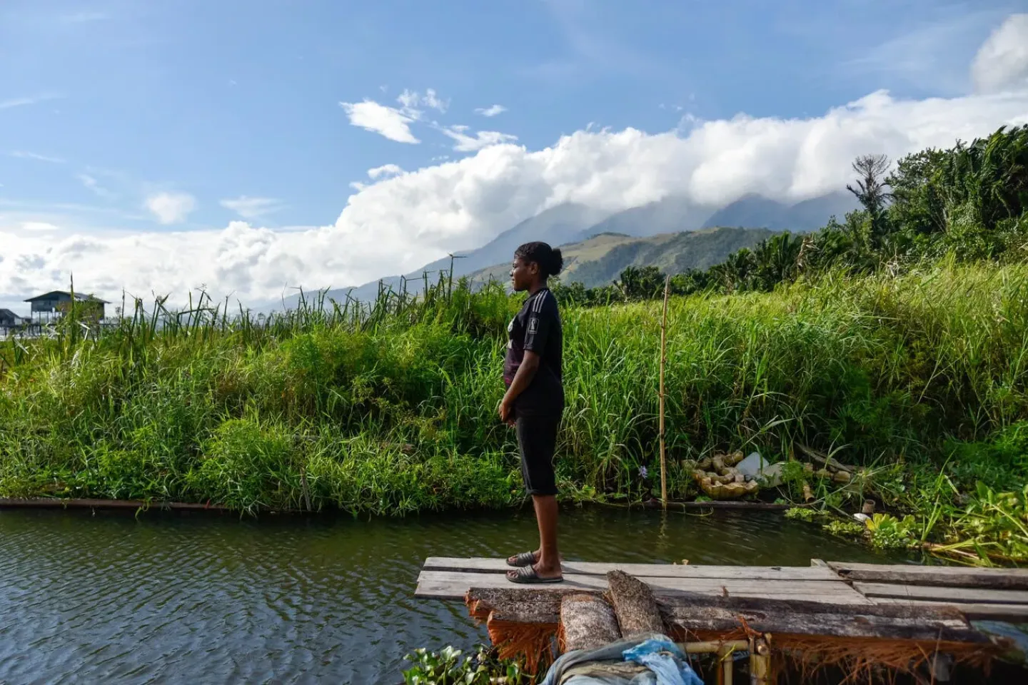 A girls stands near a body of water