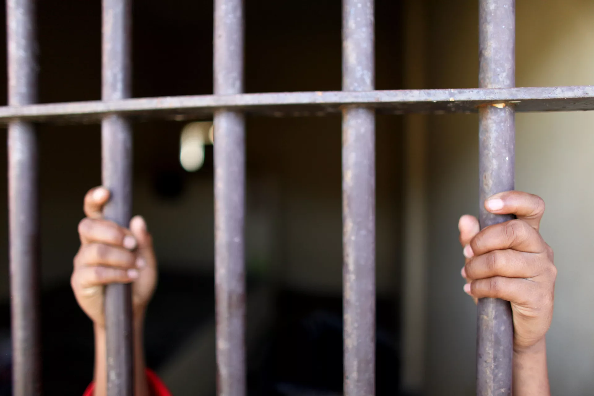 boy and prison bars
