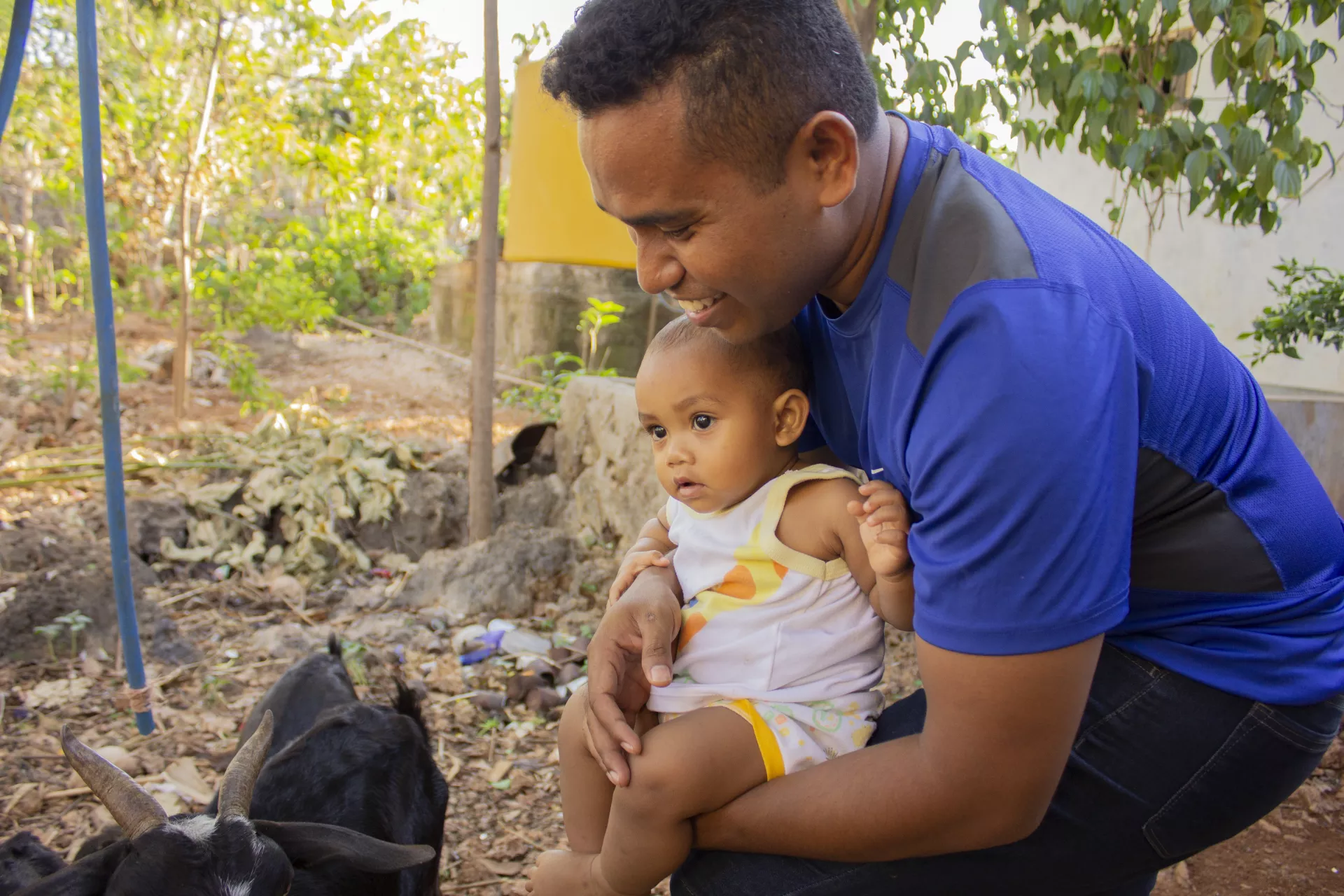El Asamau holding his son