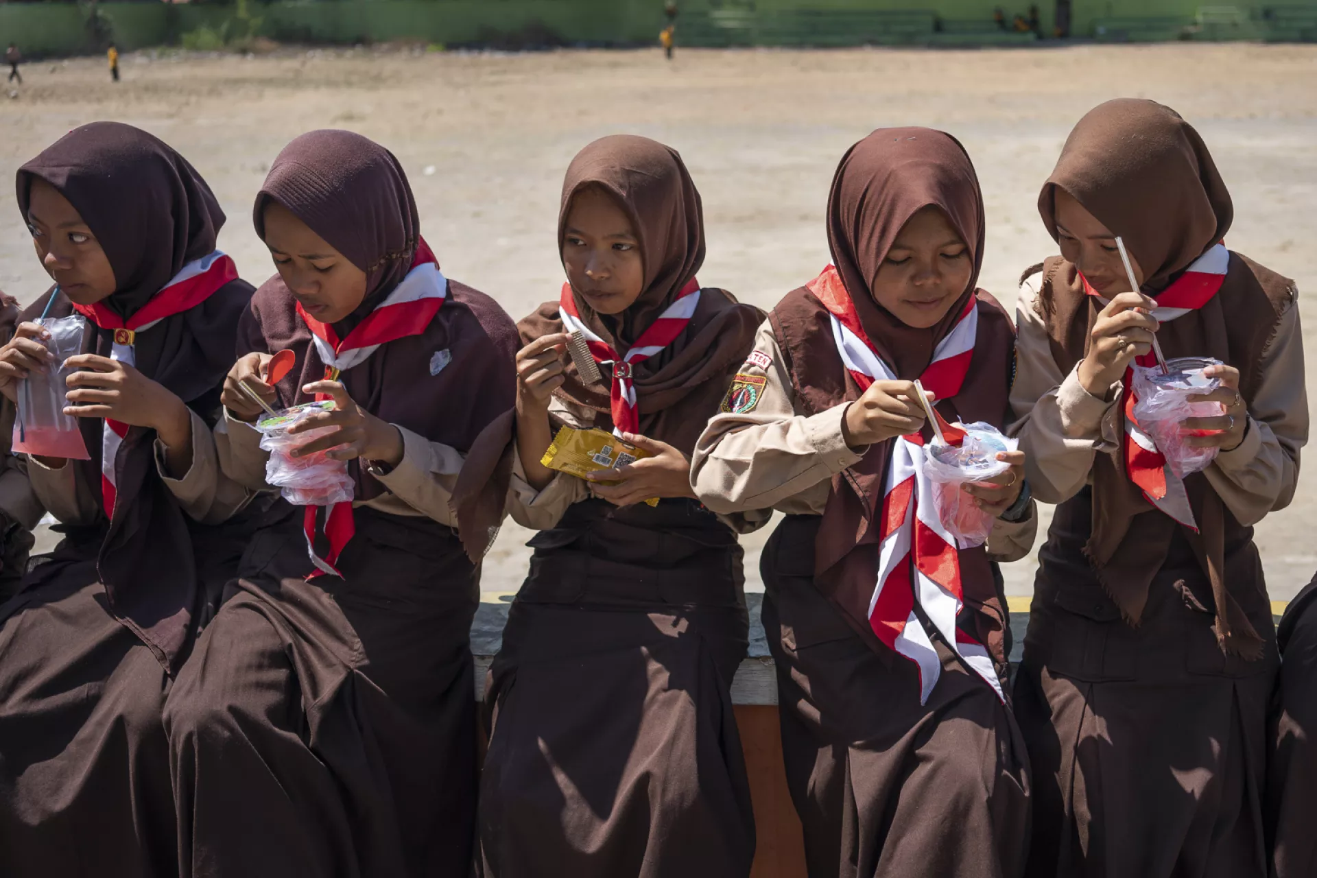 Elementary School students in Klaten, Central Java, eating and drinking snacks