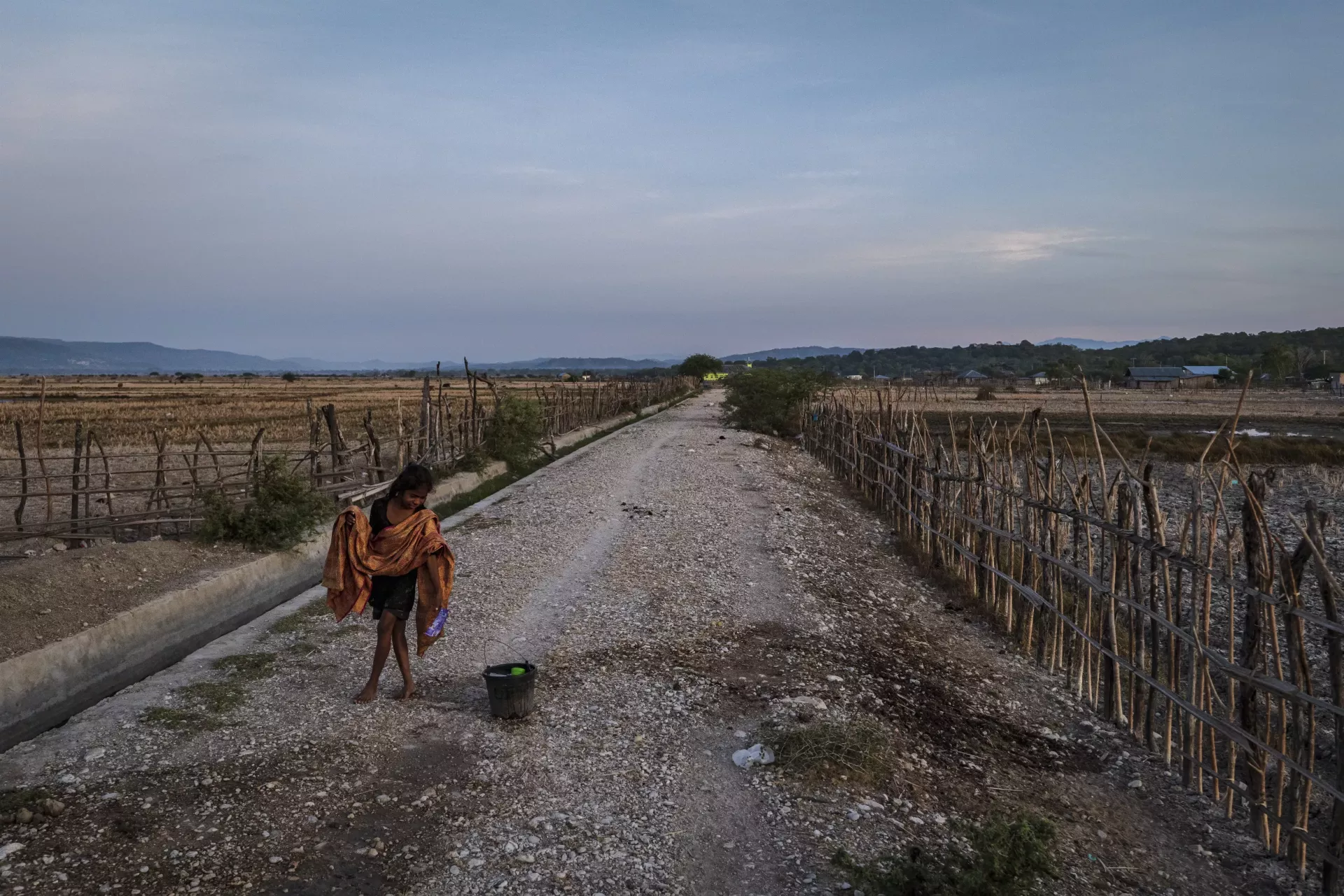 A girl walks amidst drought