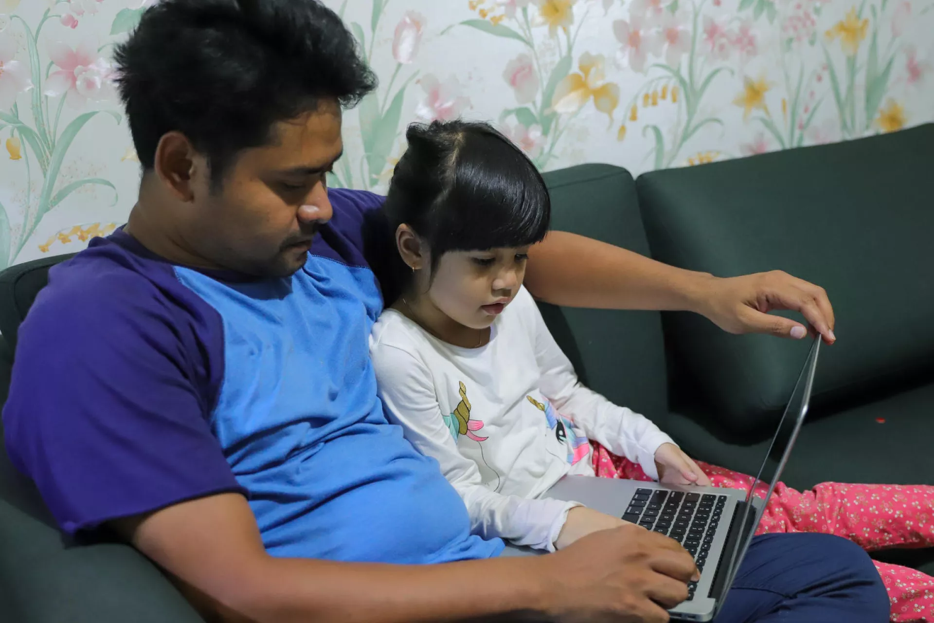 Kimy, 6, studies at home with her father