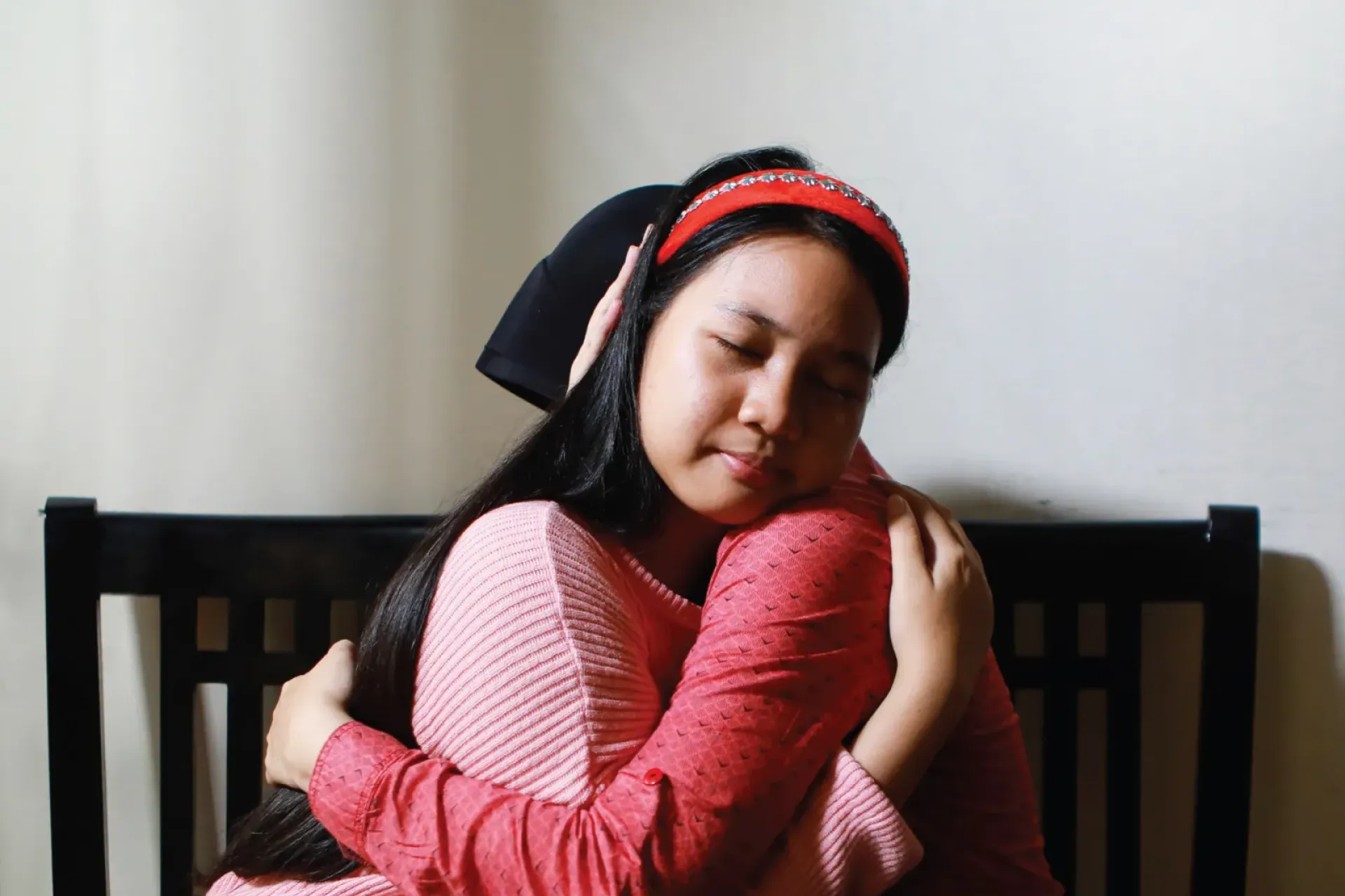 A girl hugs her mother