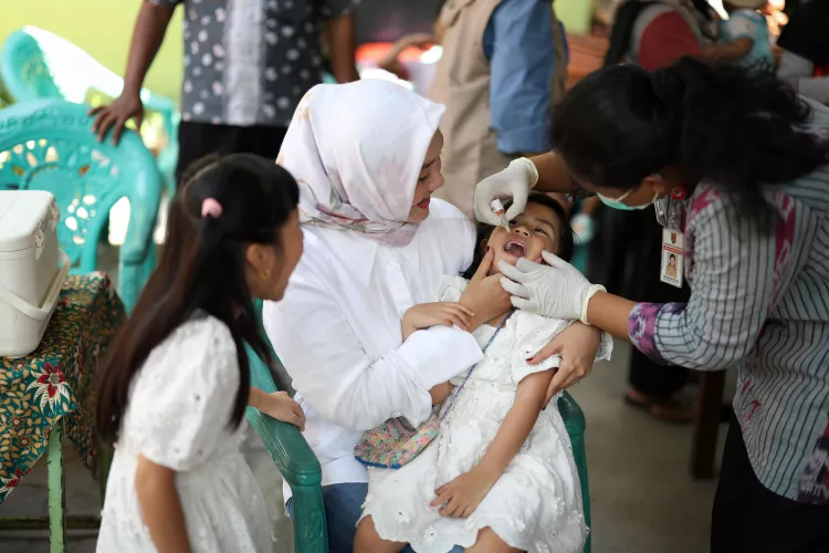 Anaya and Alesha receive the polio vaccine accompanied by their mother