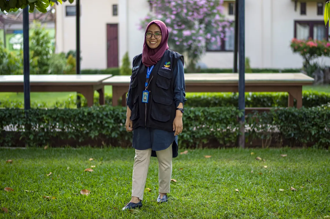 Chi Ramadhani, a social worker based in Central Sulawesi standing in the park of the Social Office office area in Palu, Central Sulawesi, Indonesia.