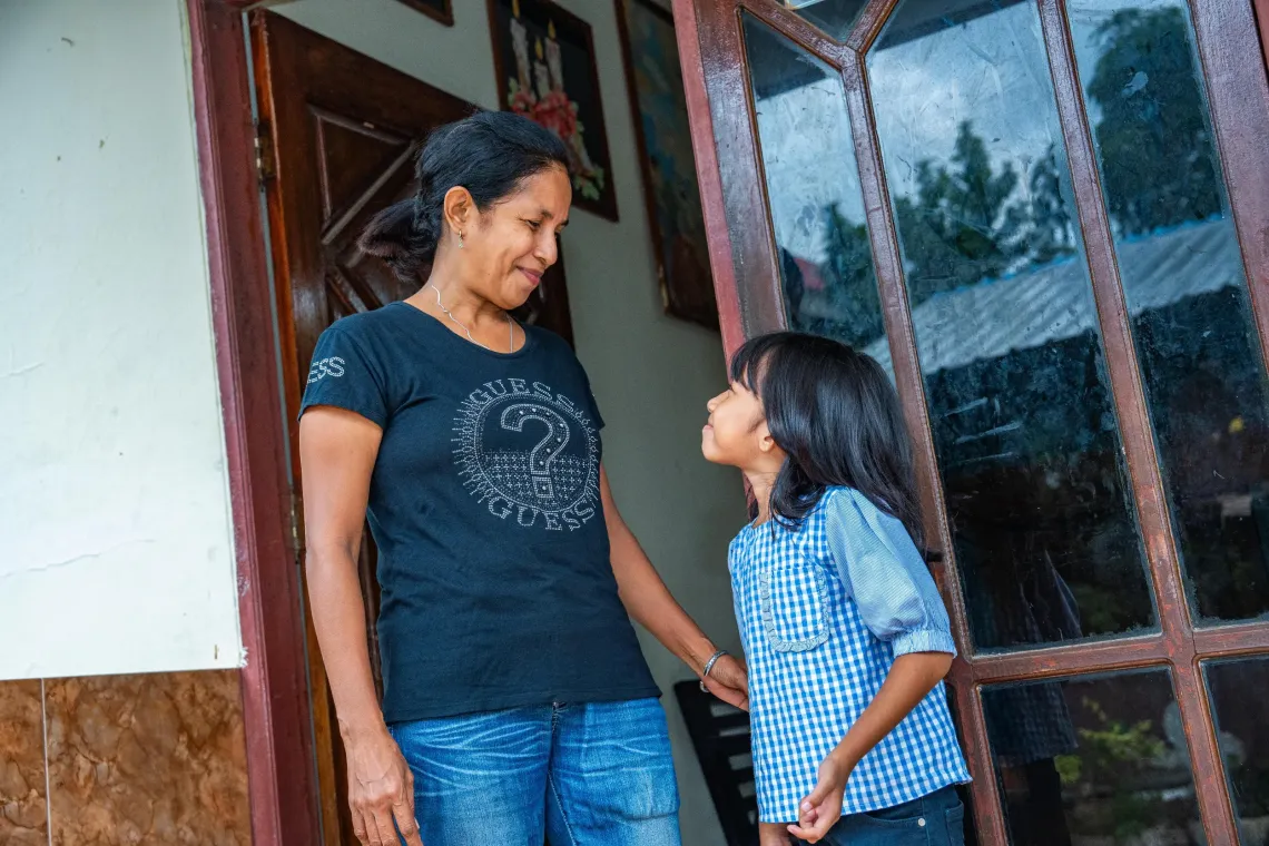 Merry and her daughter, Melvi, 7, in their home in the Kupang Municipality, East Nusa Tenggara, on 12 December 2025 