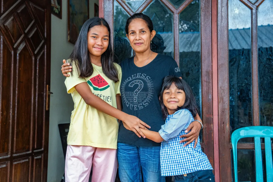 (Center) Merry and her daughter (right), Melvi, 7, in their home in the Kupang Municipality, East Nusa Tenggara, on 12 December 2025 