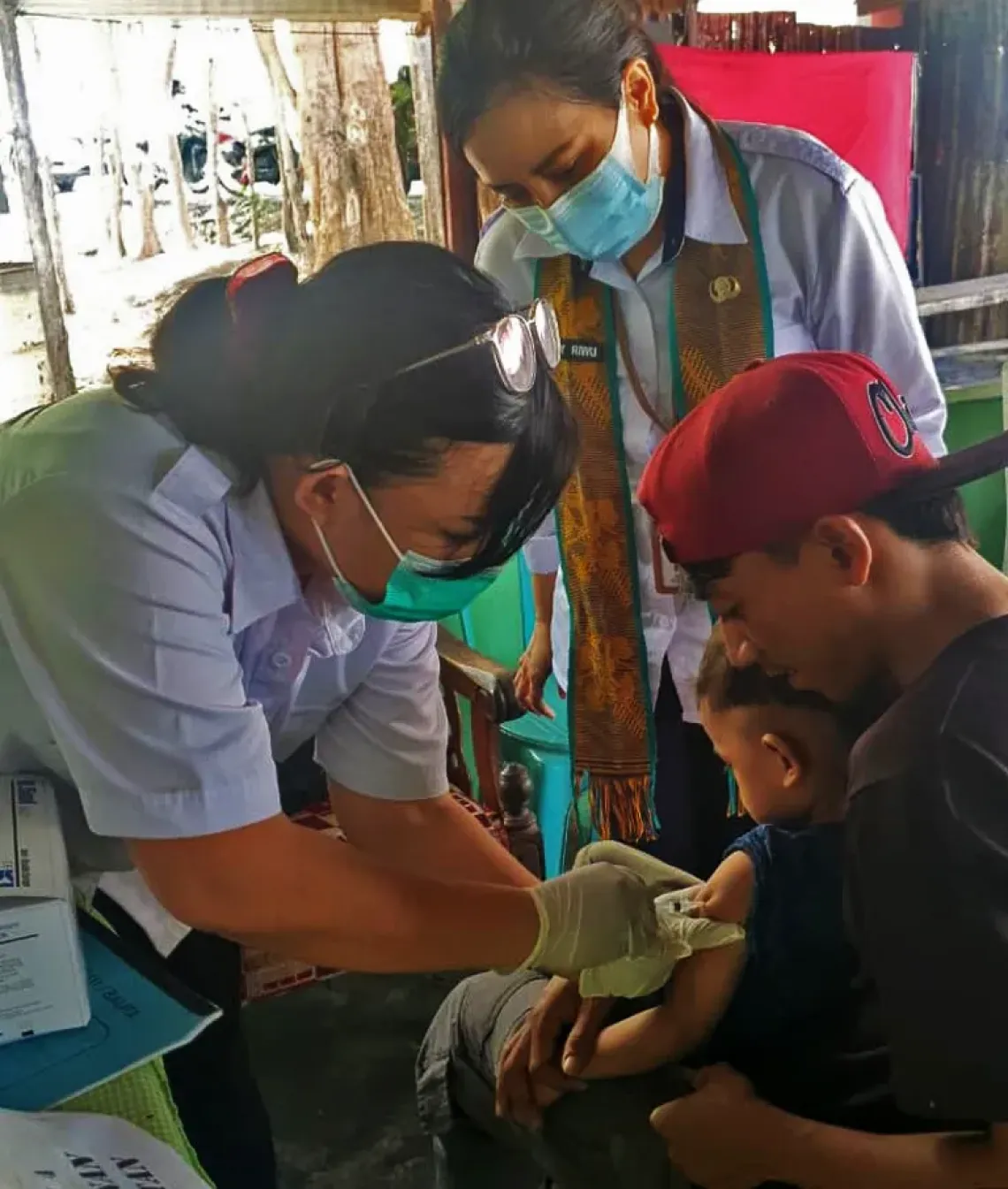 Arka is accompanied by his uncle to be immunized