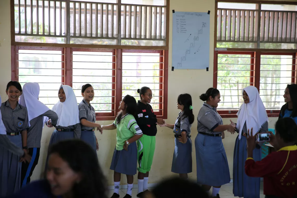 Children happily chatting in the school hallway.
