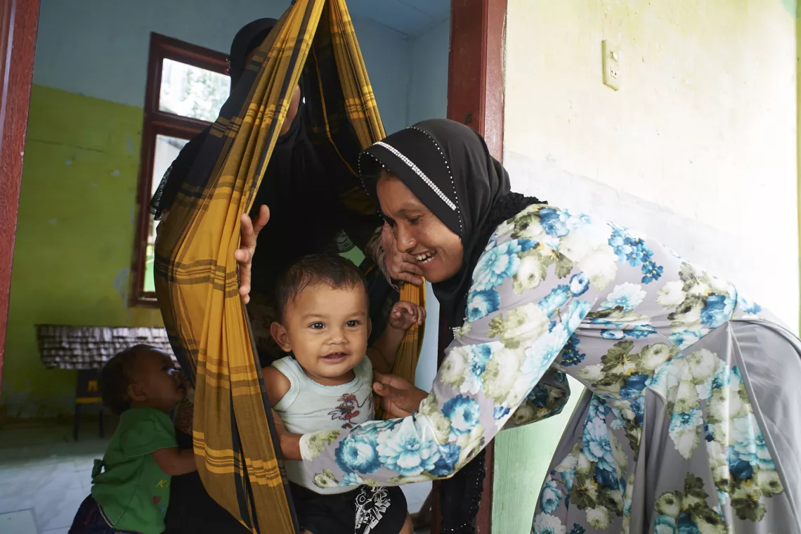 A child picked up from cocoon by the mother.